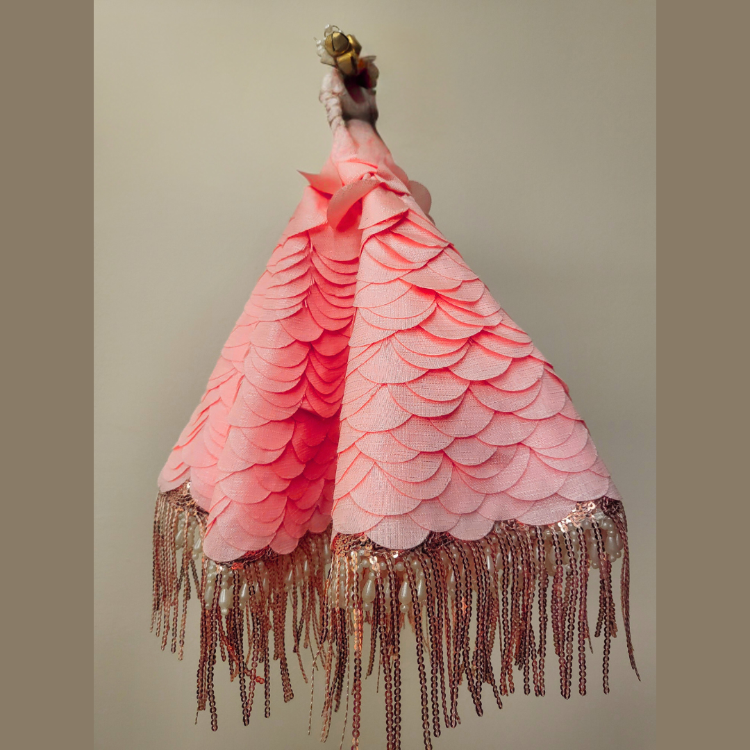 Peach thaal cover, standing view with fringe