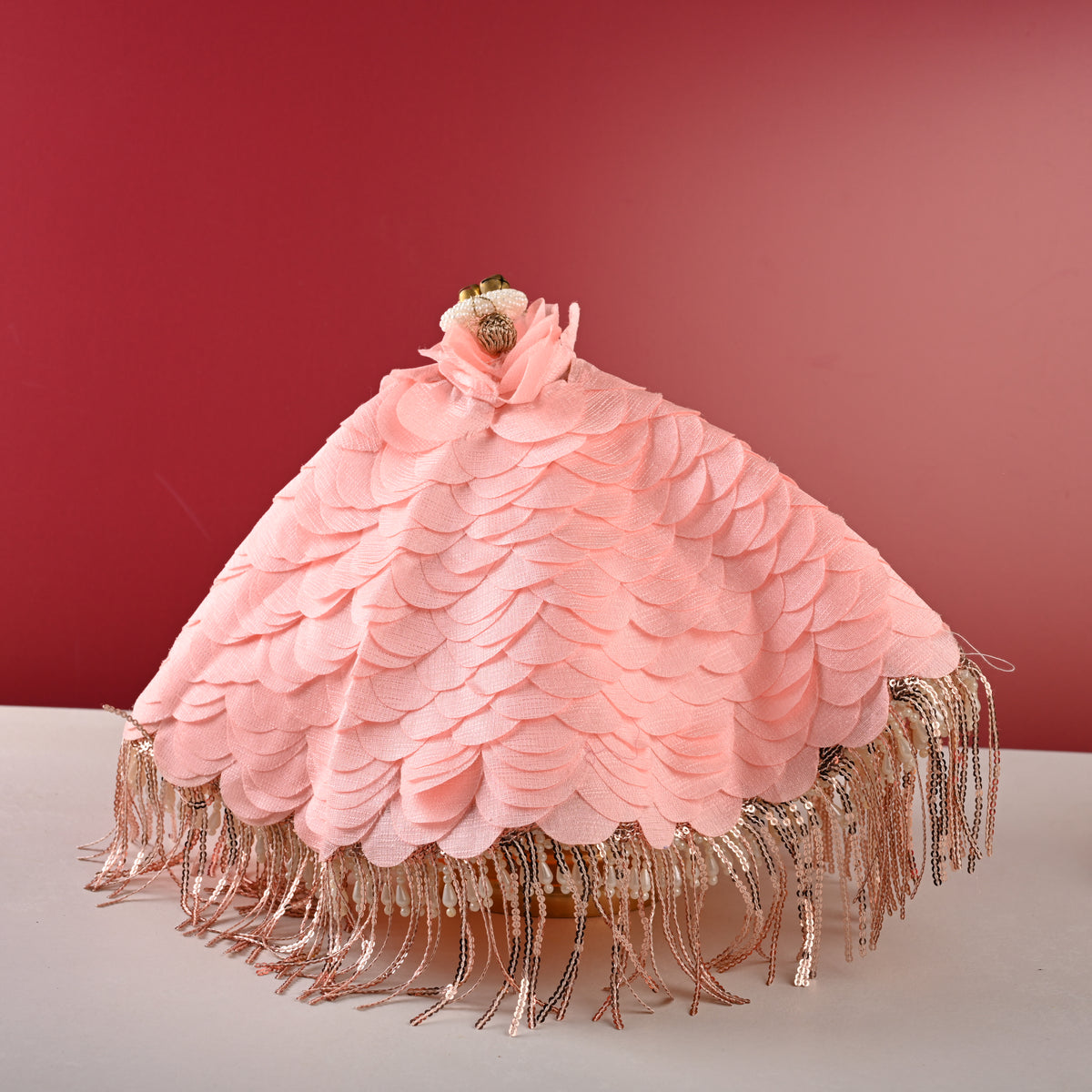 Peach thaal cover, front view on red backdrop
