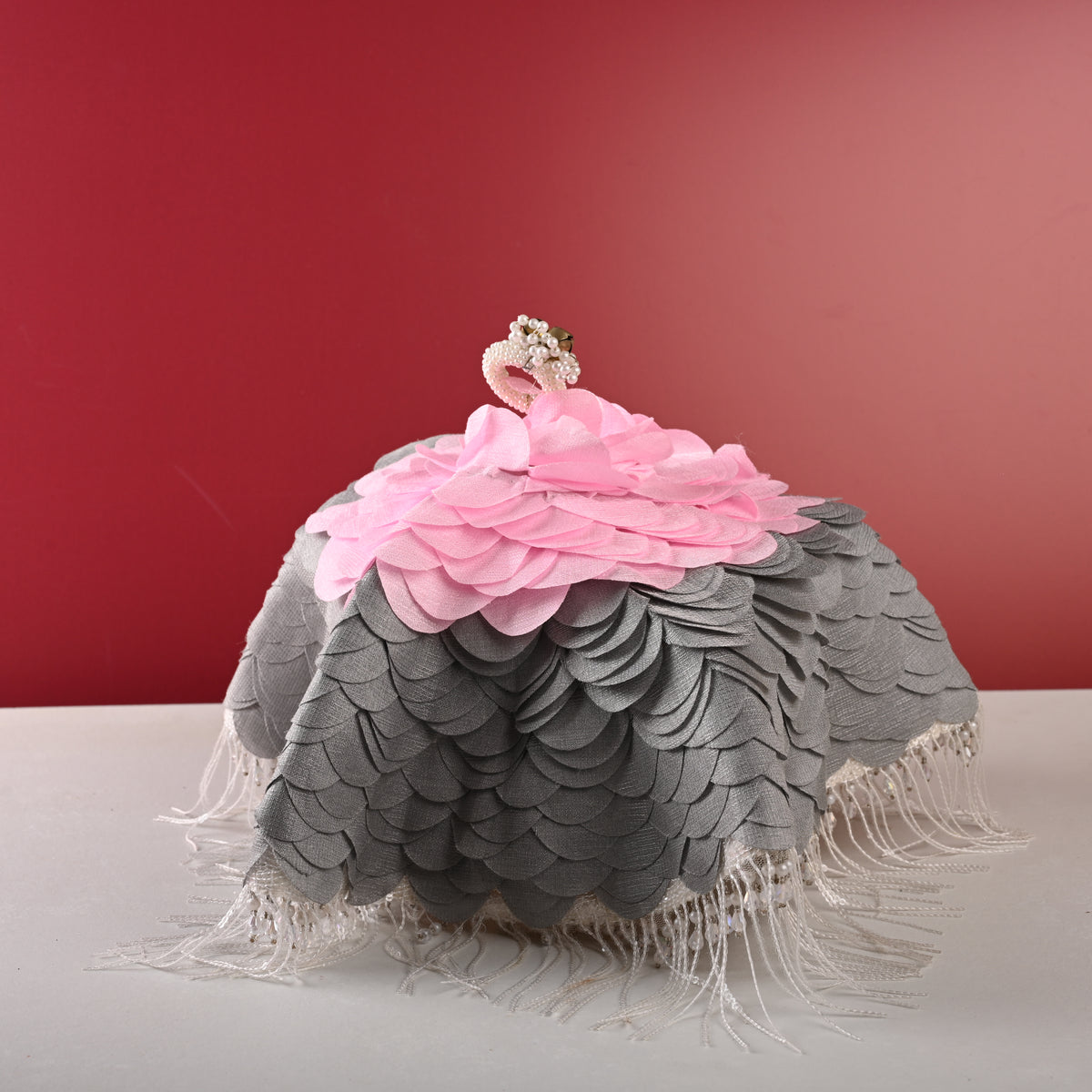 Grey thaal cover, front view on red backdrop